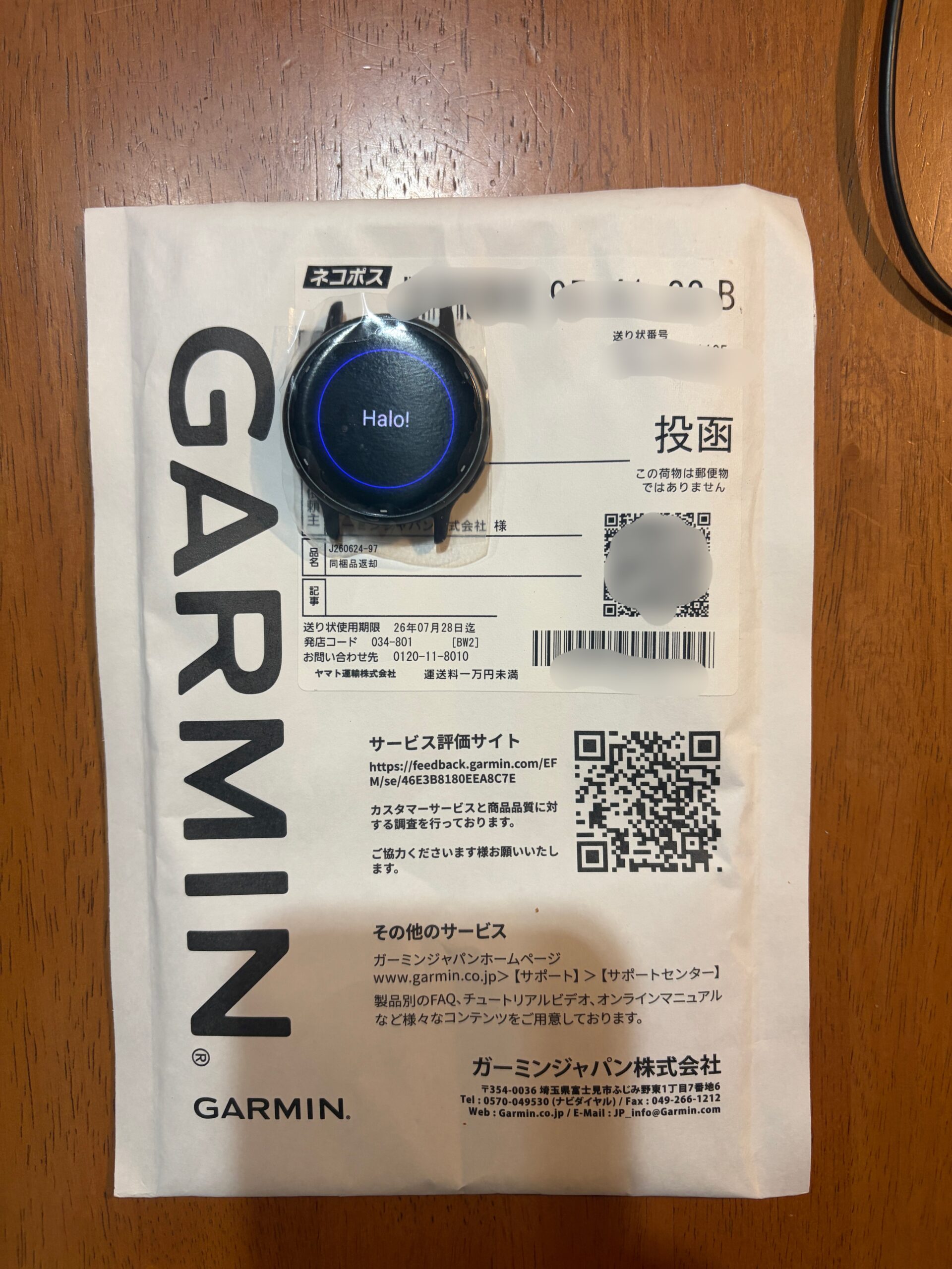 Garminから届いた交換後のvívoactive 5と返送用封筒(個人情報部分は加工済み)